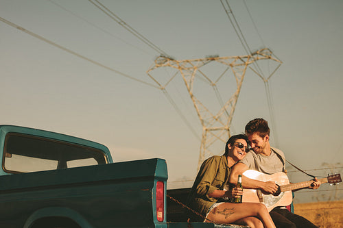 Couple enjoying on a road trip in their pick up truck