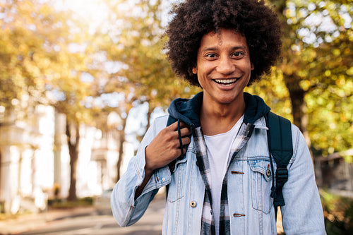 Young man with backpack going to school college