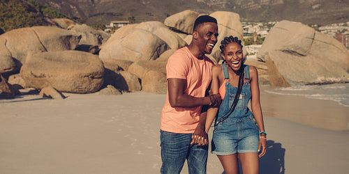 Laughing couple on summer vacation at the beach