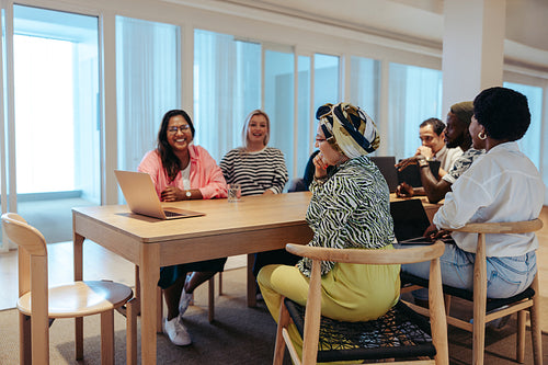 Diverse team having a virtual client meeting in a modern office environment