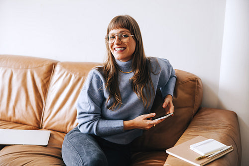 Businesswoman smiling at the camera in an office lobby