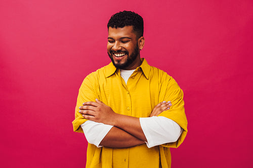 Carefree young man smiling happily in a studio