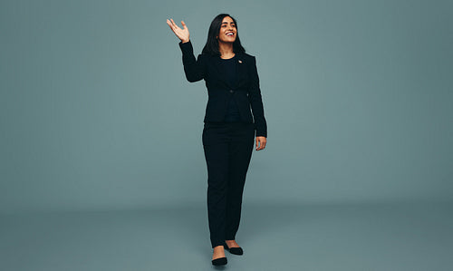 Patriotic young politician waving her hand in a studio