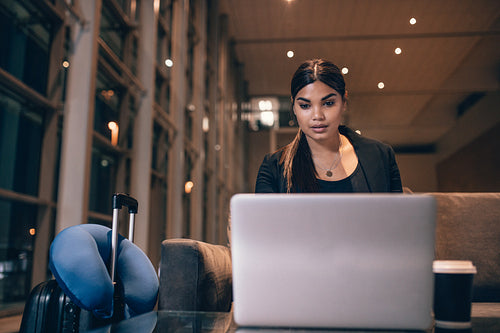 Businesswoman waiting for her flight at airport lounge