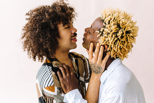 Affectionate male lovers looking at each other