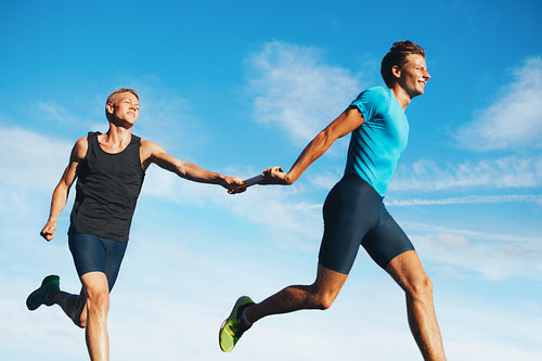 Young athletes running in a track relay