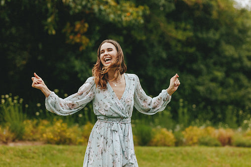 Cheerful woman dancing at the park