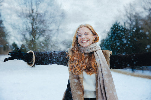 Enjoying snowfall with friends in winter coats