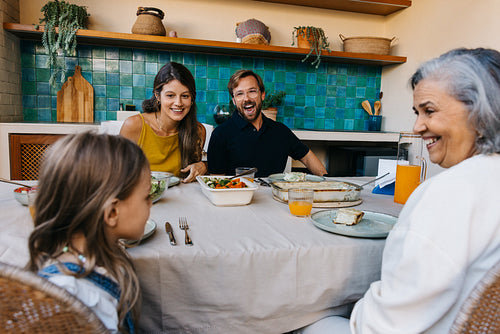 Happy multigenerational family dinner at home kitchen table