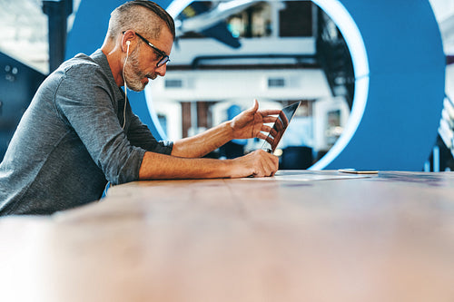 Mature businessman speaking during a virtual meeting in an office