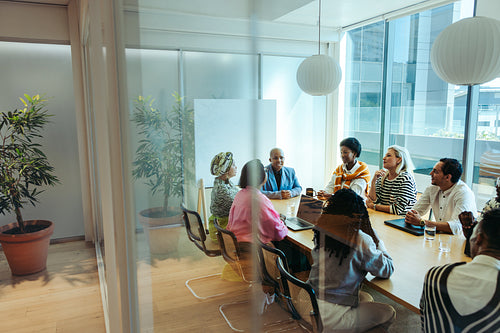 Team collaborating in a meeting room with an aesthetic design and natural lighting