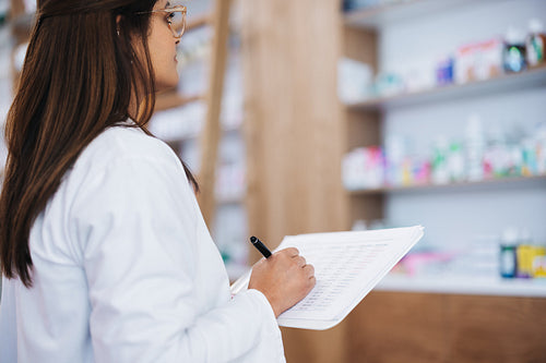 Pharmacist doing a stock take in a drug store
