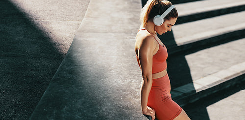 Athlete taking a break from her workout while enjoying