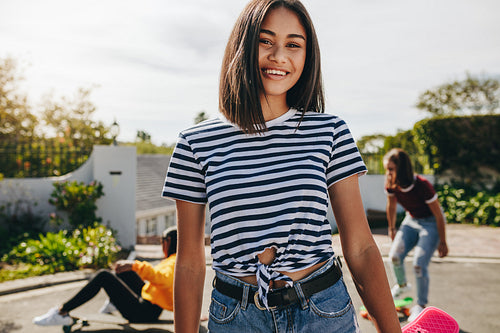 Girls skating in the street on a sunny day