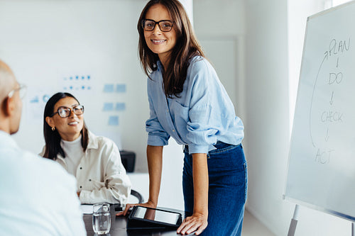 Business woman having a meeting with her team in a boardroom