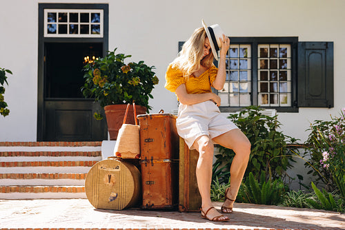 Stylish female traveller waiting for her ride to arrive outside