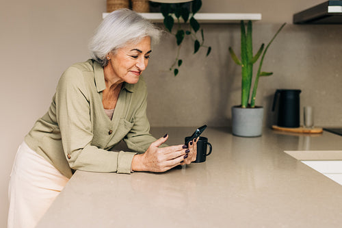Mature woman taking a video call at home