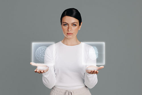 Portrait of a tech-savvy woman holding two graphic icons in a studio