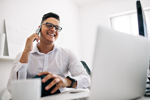 Man talking on mobile phone in office