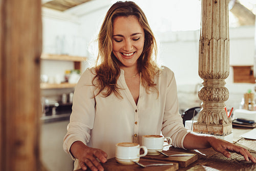 Woman barista working in a cafe