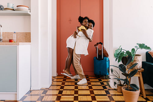 Excited mother and daughter's joyful reunion at the door
