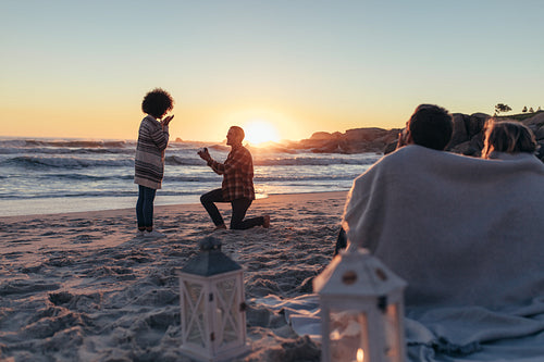 Marriage proposal at sunset beach