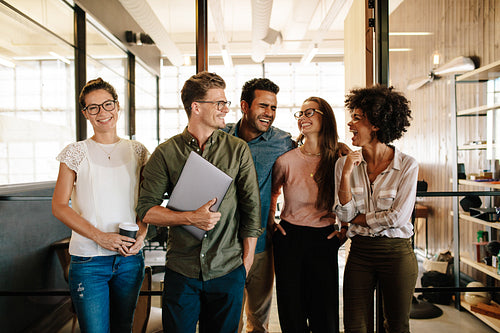 Successful business team standing together and smiling