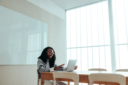 Black female entrepreneur conducting a video call with a laptop