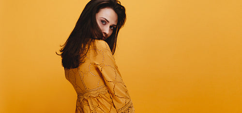 Beautiful young woman in orange dress