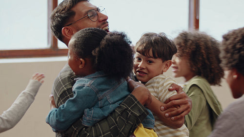 Back to school excitement: Happy elementary school children running to embrace their teacher on first day of class