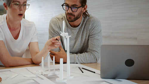 Business woman sharing her ideas and expertise in a wind energy collaboration with her team