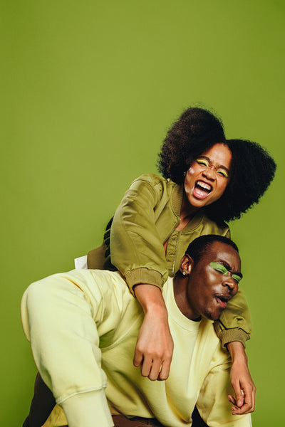 Friends share a piggyback dance and singing moment in the studio with laughter and trust