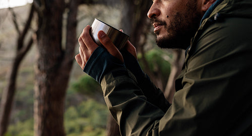 Close up of male hiker drinking coffee