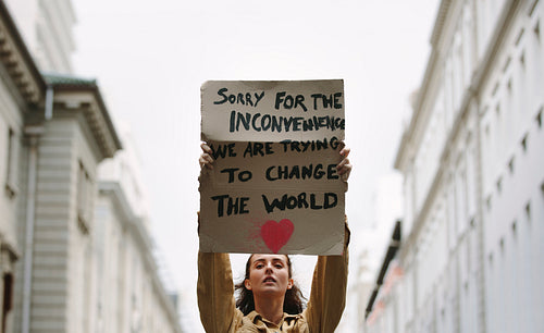 Woman holding poster and protesting