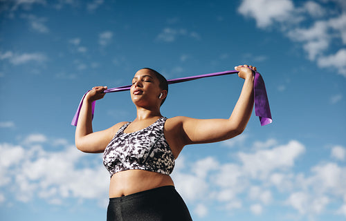 Healthy woman exercising with resistance band