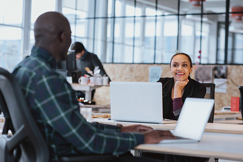 Young creative designers having friendly discussion