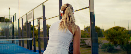 Padel players competing in an intense match on a vibrant blue outdoor court