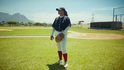 Female baseball pitcher ready on the field