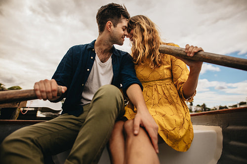 Close up of a romantic couple kissing on a boat date