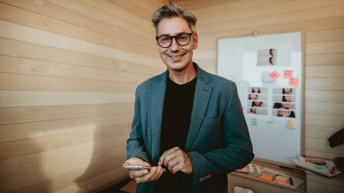 Smiling businessman standing in office training room