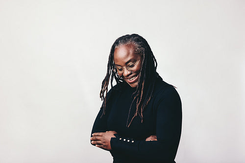 Happy middle aged woman smiling cheerfully in a studio