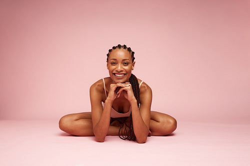 Woman sitting on floor with hand on chin