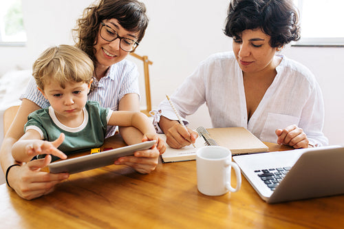 Female couple at home with kid