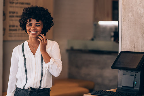 Female restaurant owner talking on phone