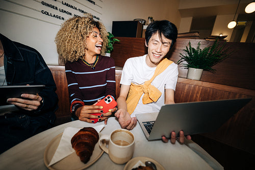 Young business people from Generation Z collaborating in cafe culture