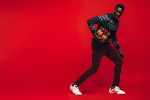 African american man running with a gift