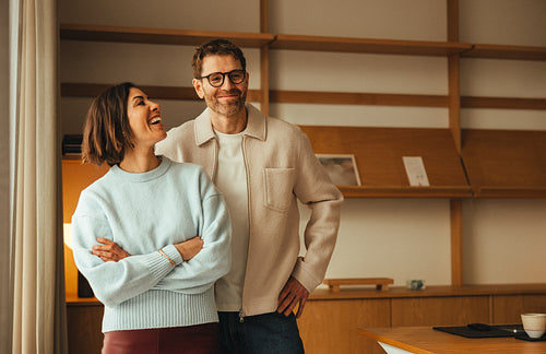 Colleagues laughing together in a small office