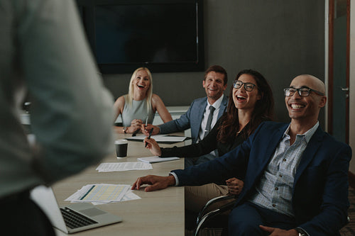 Business people laughing during a conference meeting