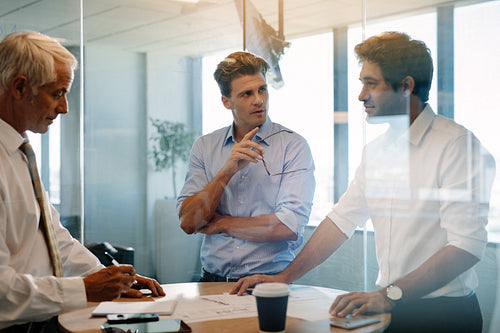 Team of corporate professionals meeting around a table
