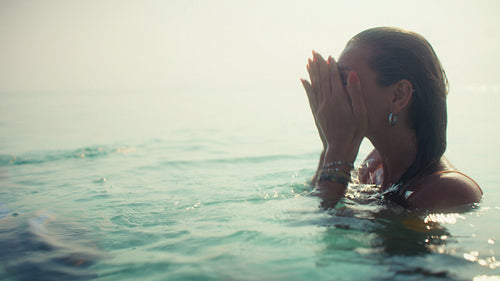Mother and daughter share a loving embrace during their luxurious tropical resort beach vacation